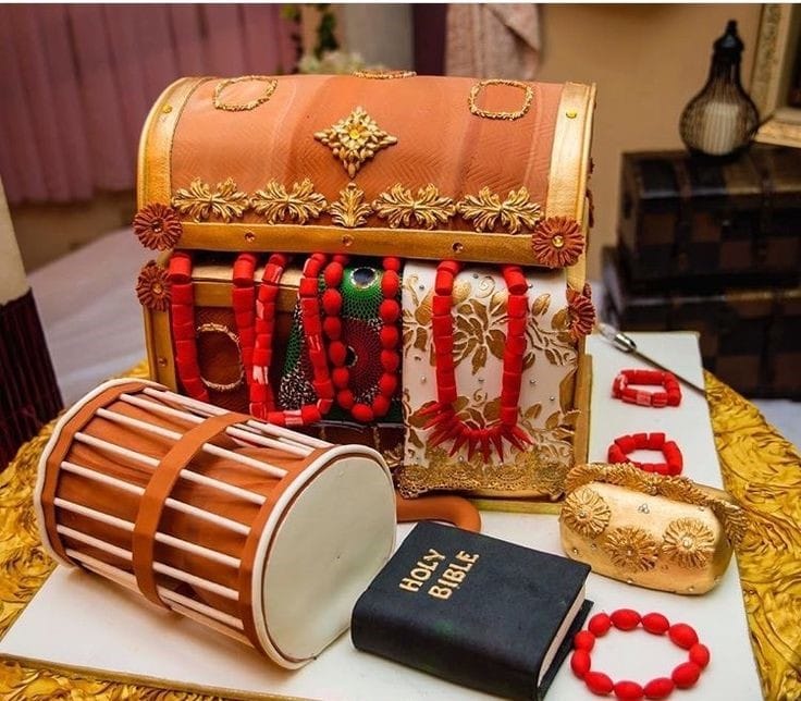 Edible traditional drum cake and jewelry box with a bible and gold purse at the side